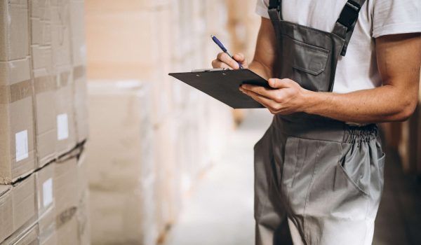 Young man working at a warehouse with boxes